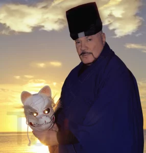 Grandmaster Alex Anatole holding the ritual Fox mask